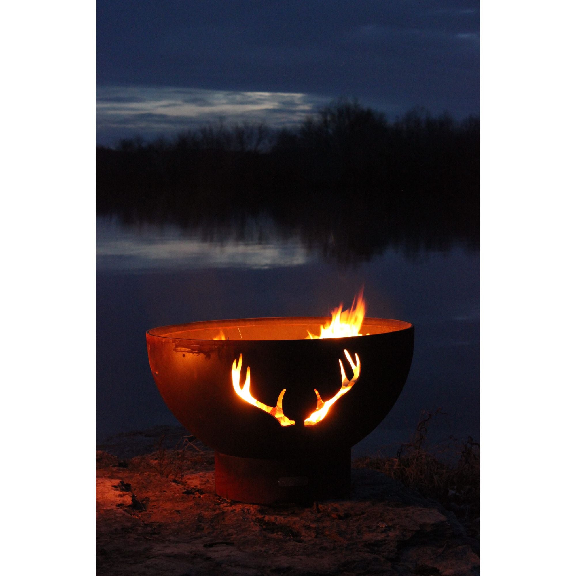 Fire pit with glowing flames in a dark outdoor setting