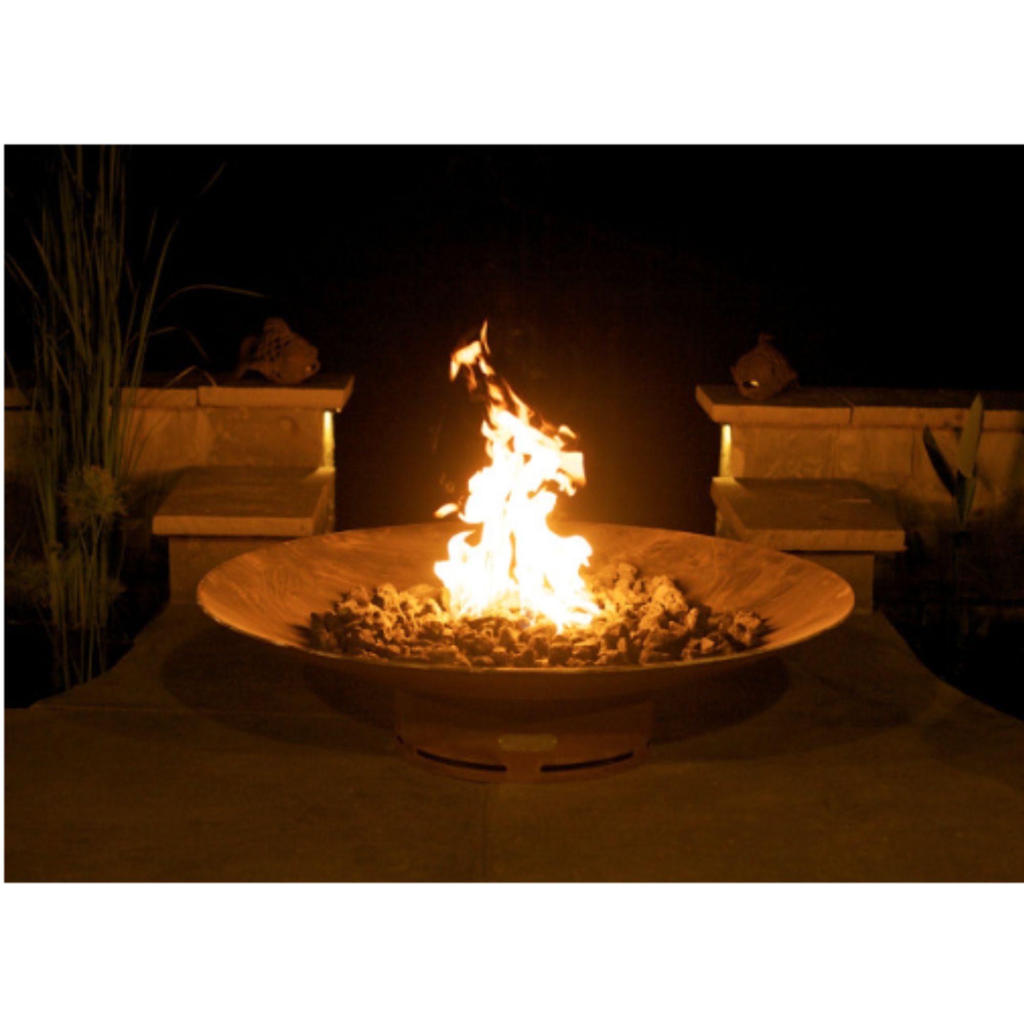 Fire pit with flames burning in a dark outdoor setting