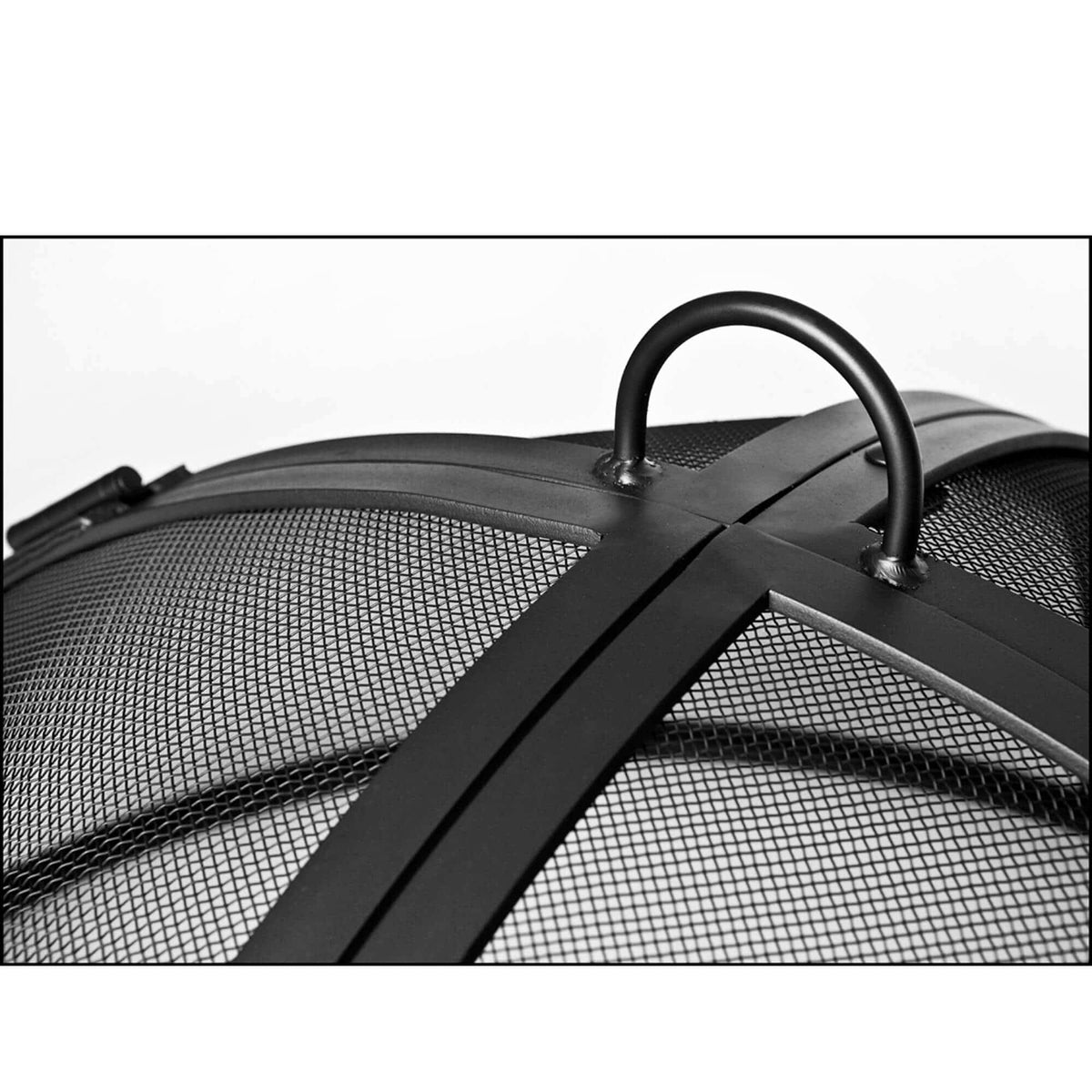 Close-up of a black metal mesh fire pit cover with a curved top handle and cross-bracket design, shown against a plain white background.