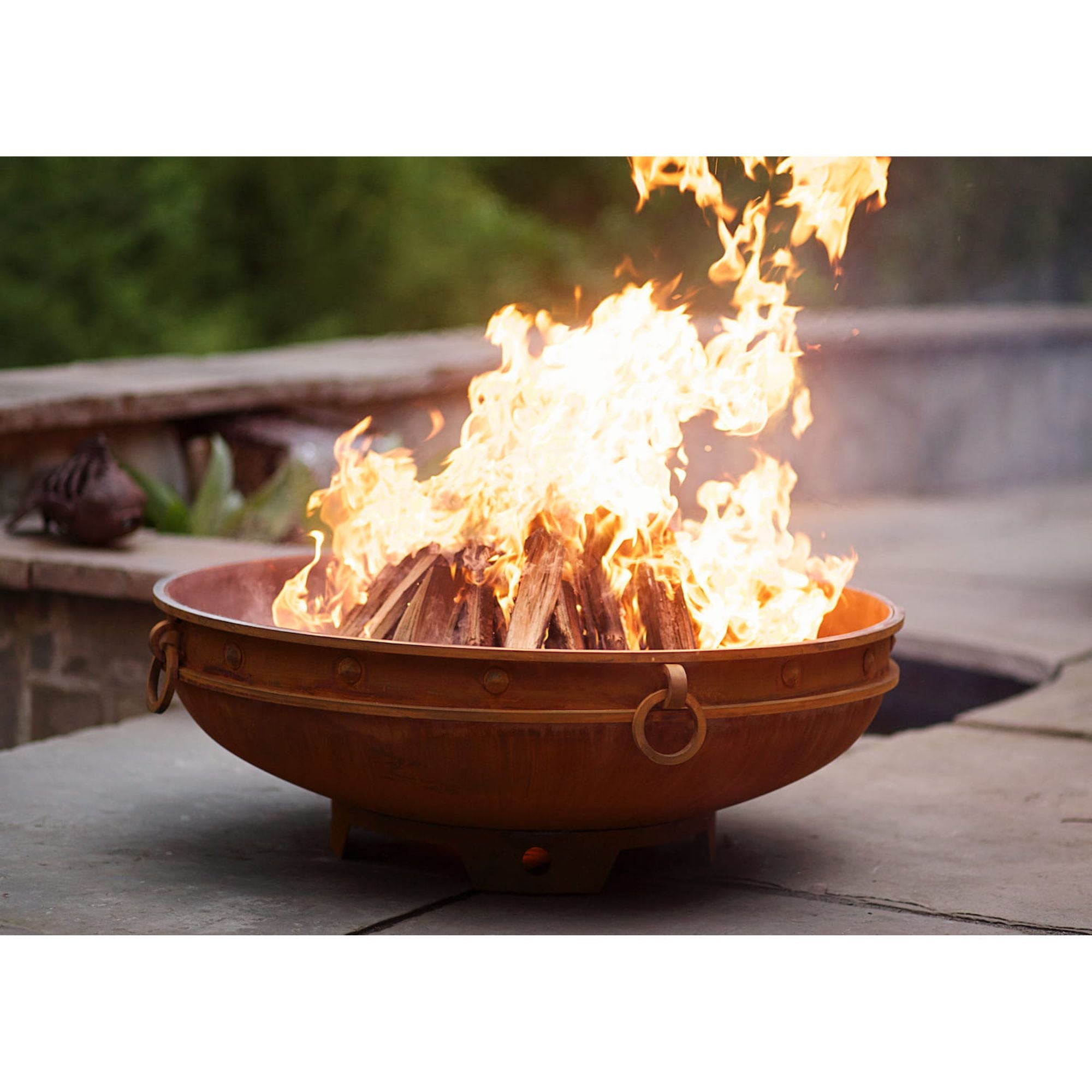 Fire pit with flames on a wooden deck