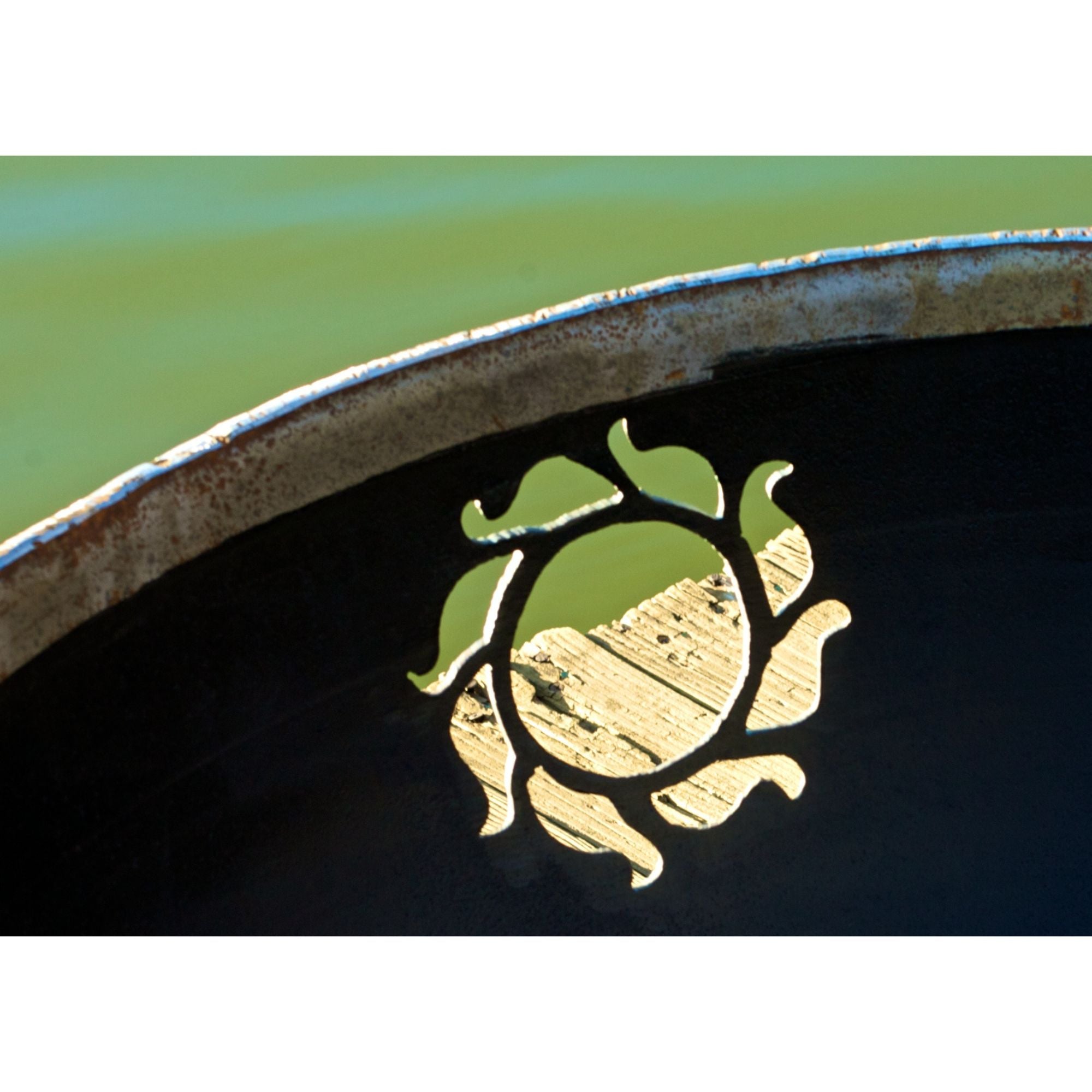 Decorative metal design with a stylized face on a black background