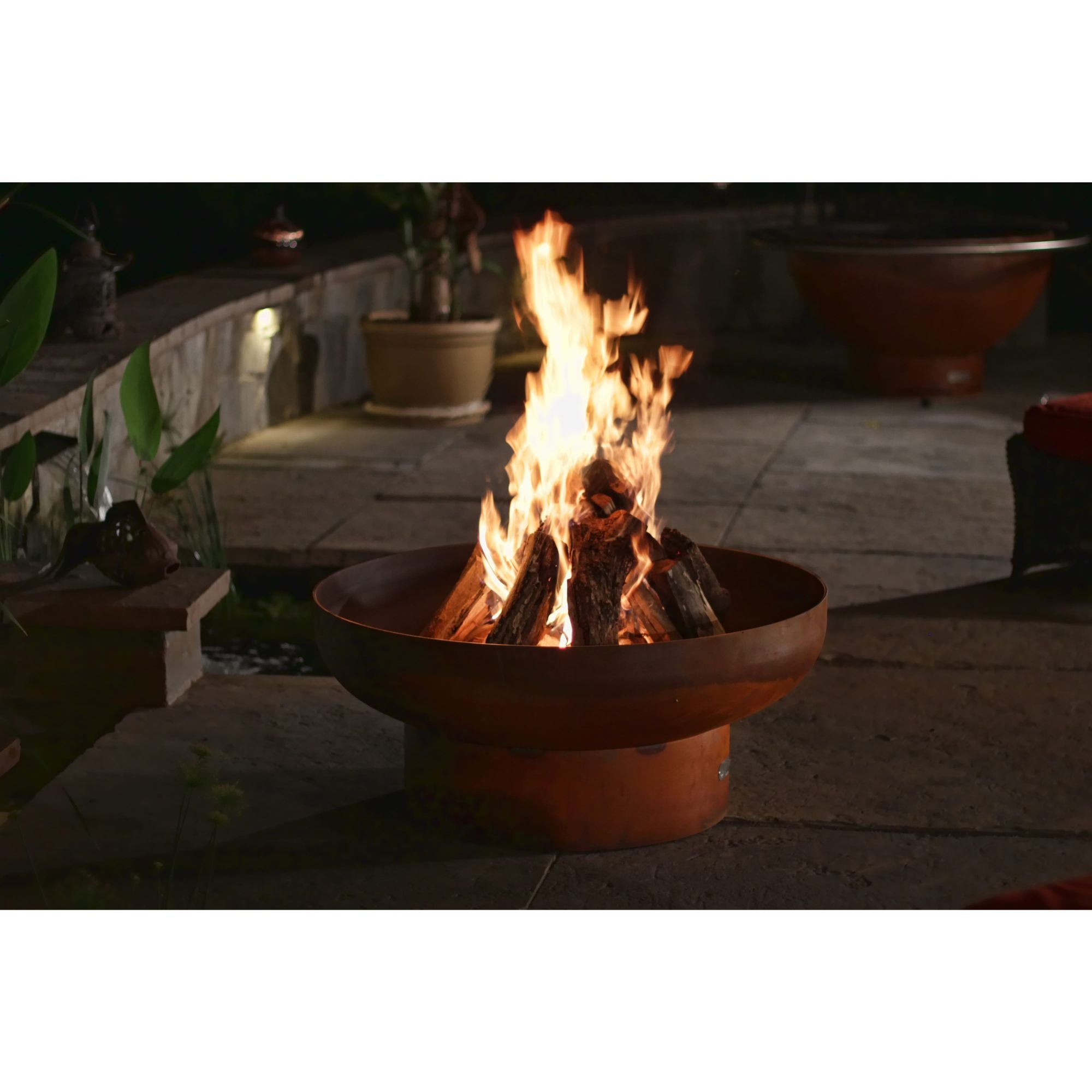 Fire pit with flames burning in an outdoor setting