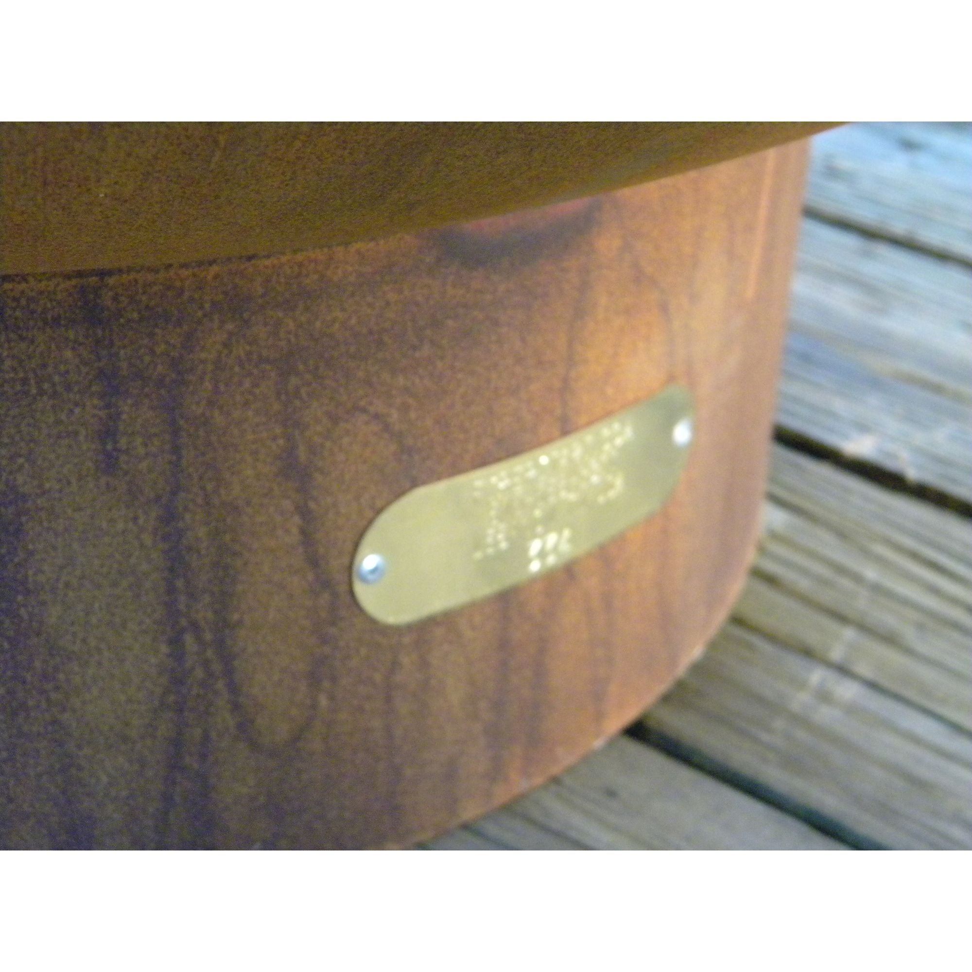 Rust colored firepit on a wooden floor background