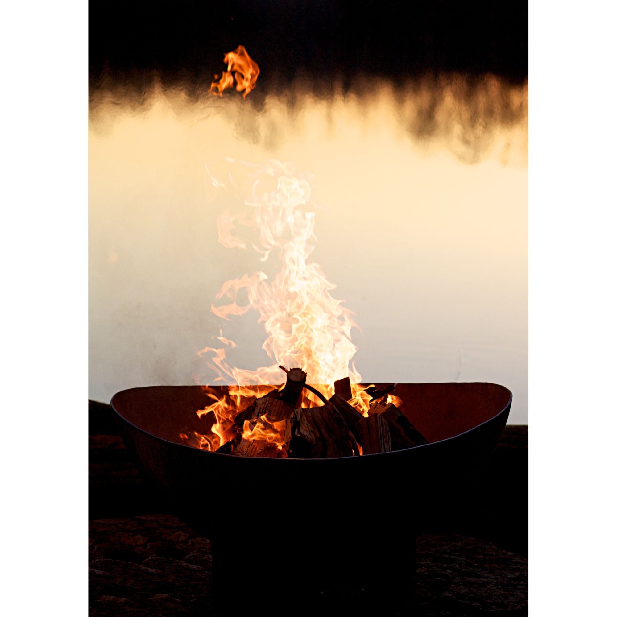 Fire pit with flames against a dark background