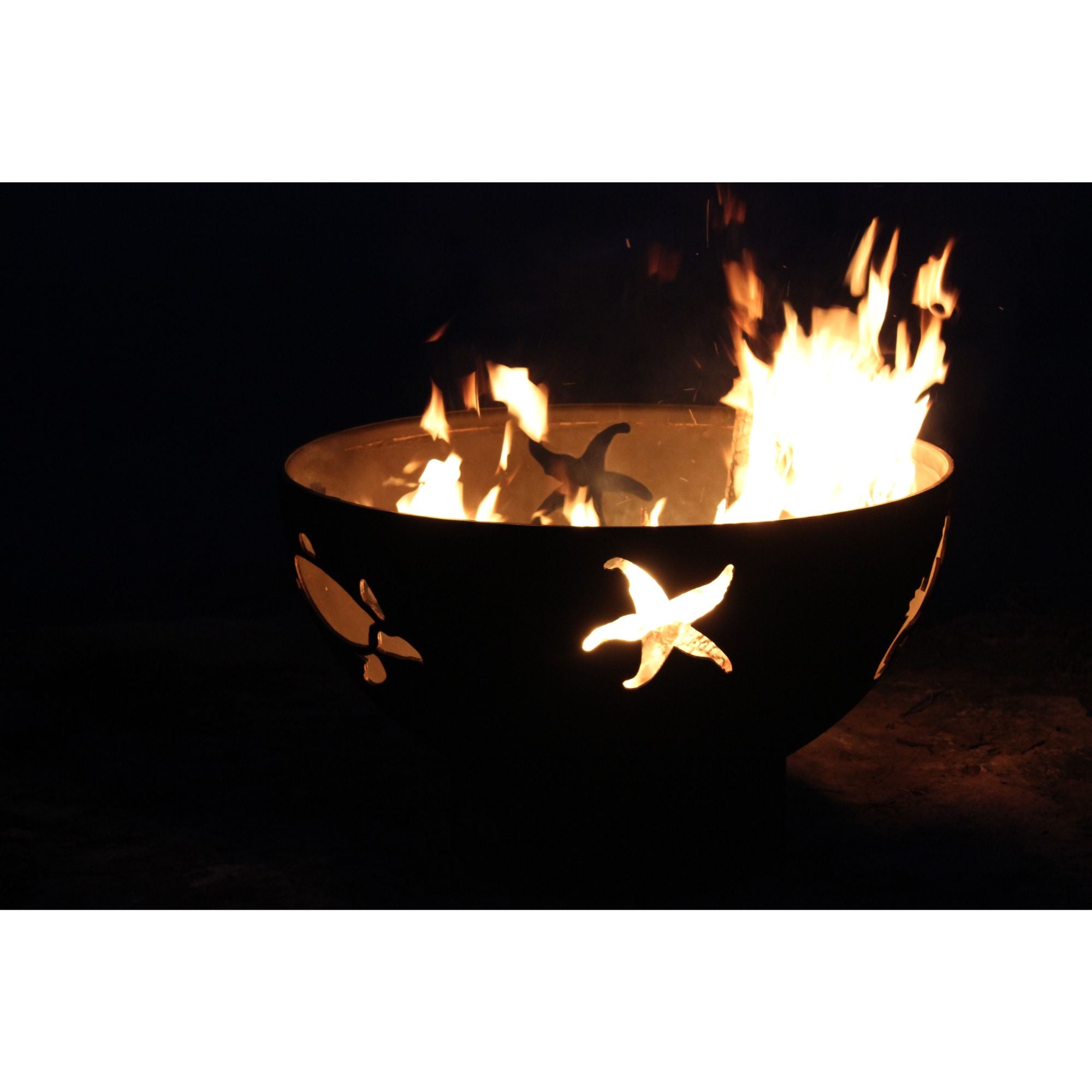 Fire pit with cut-out sea creatures designs on a dark background
