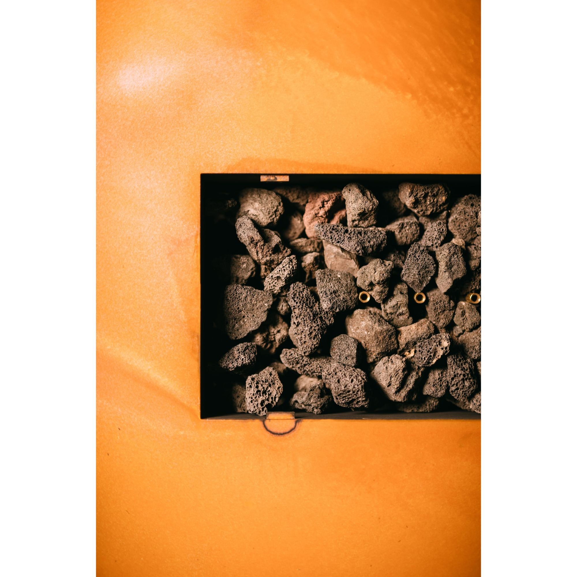 Close-up of dark-colored rocks on a black background with an orange border