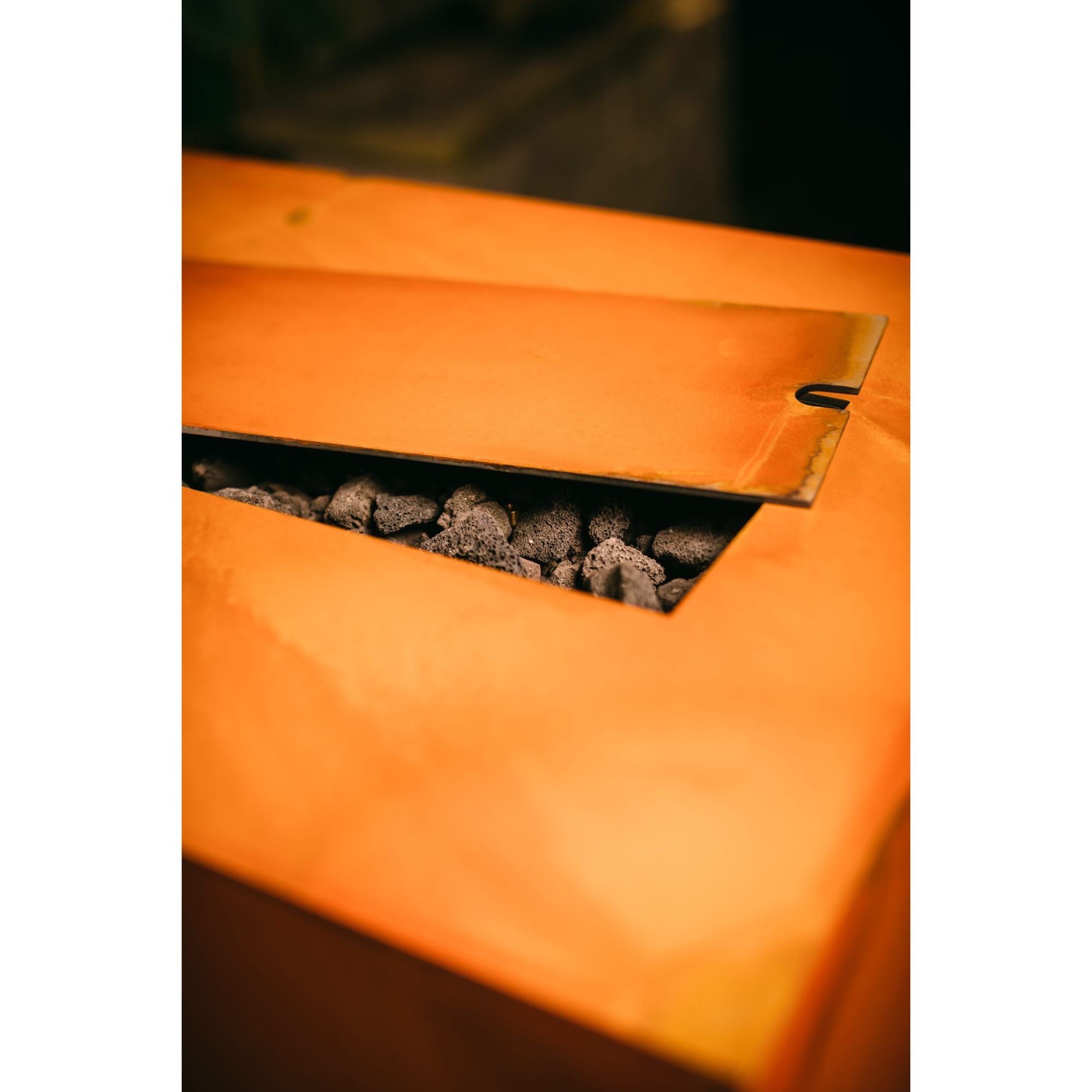 Close-up of an orange fire pit with glowing embers inside