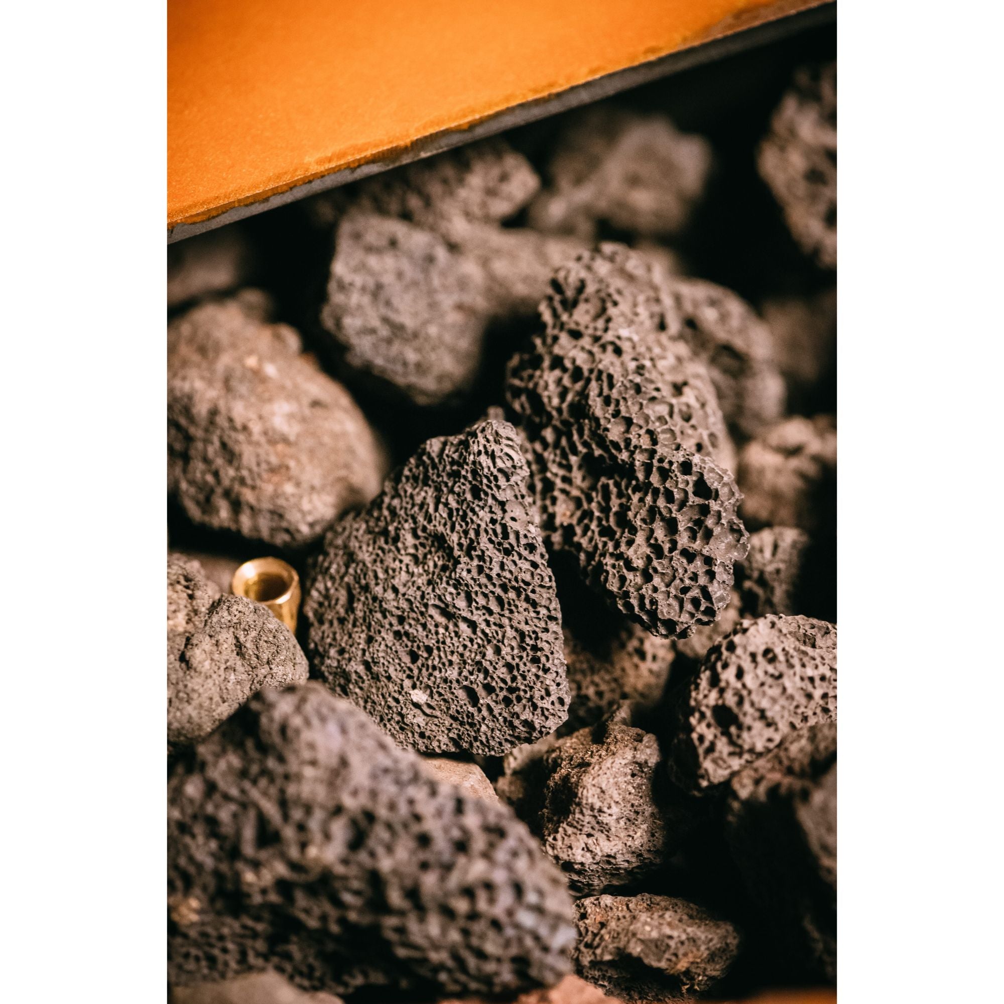 Close-up of dark gray volcanic rocks with a white background