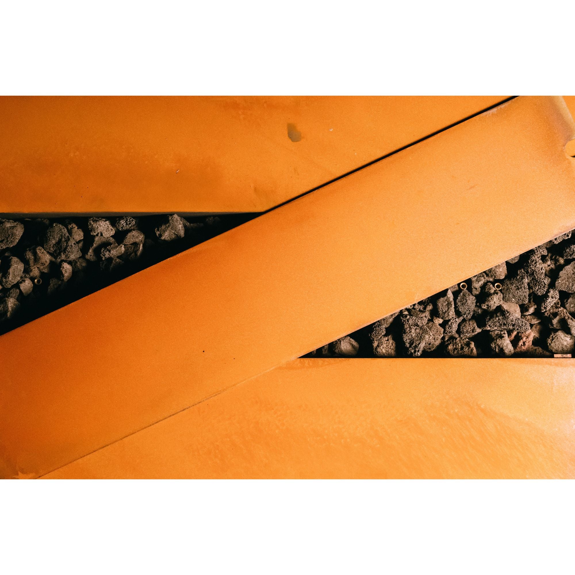 Close-up of a textured orange surface with a black strip