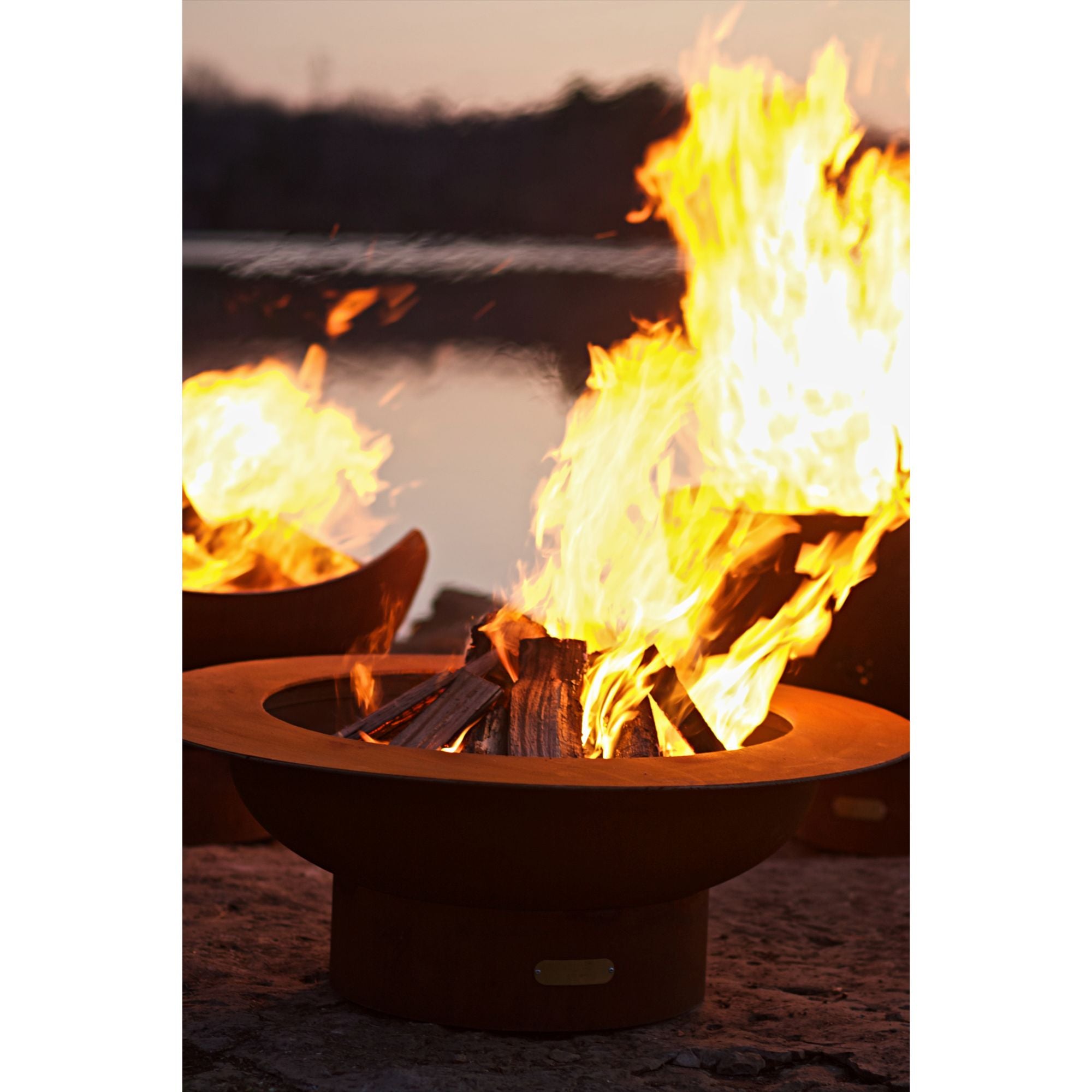 Two fire pits with flames burning brightly against a dark background