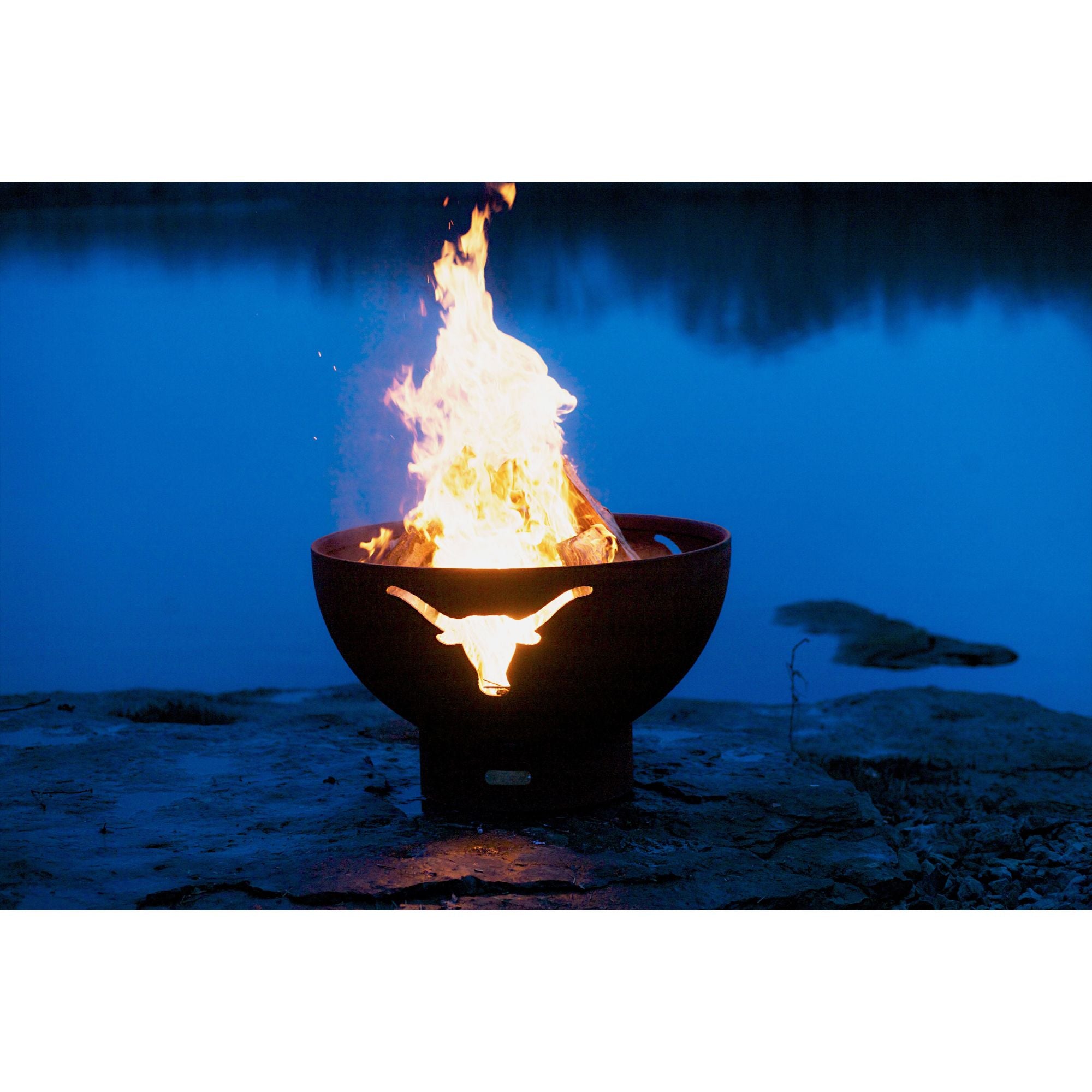Fire pit with flames burning in a dark outdoor setting