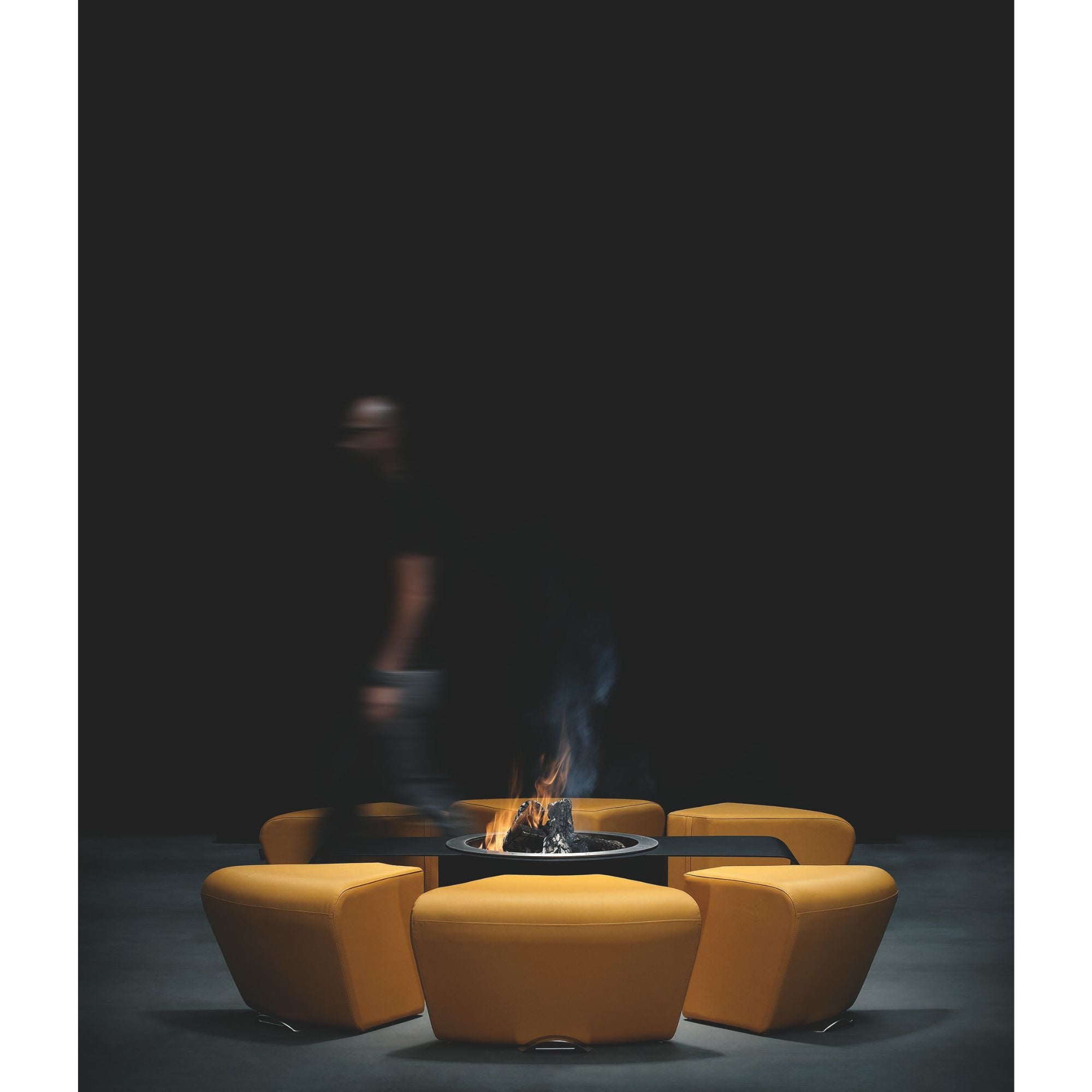 Orange outdoor chairs around a fire pit with a dark background