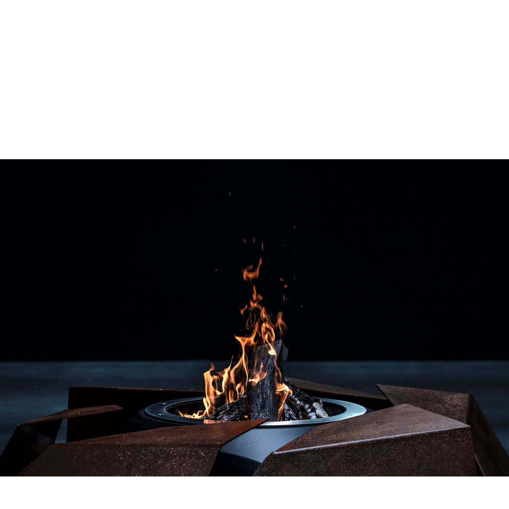 close up of a firepit with flames burning, set against a black background