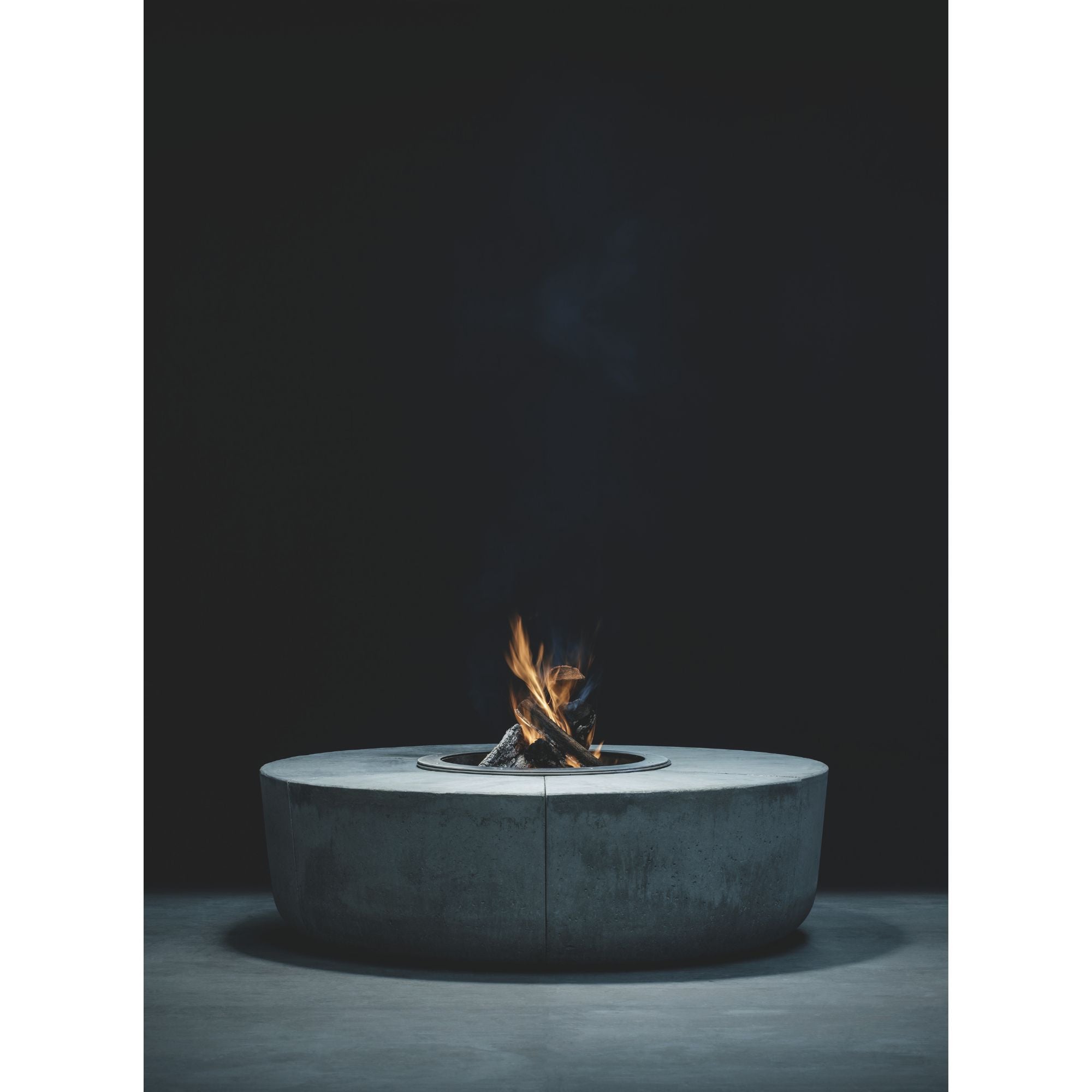 Modern fire pit table with flames on a dark background