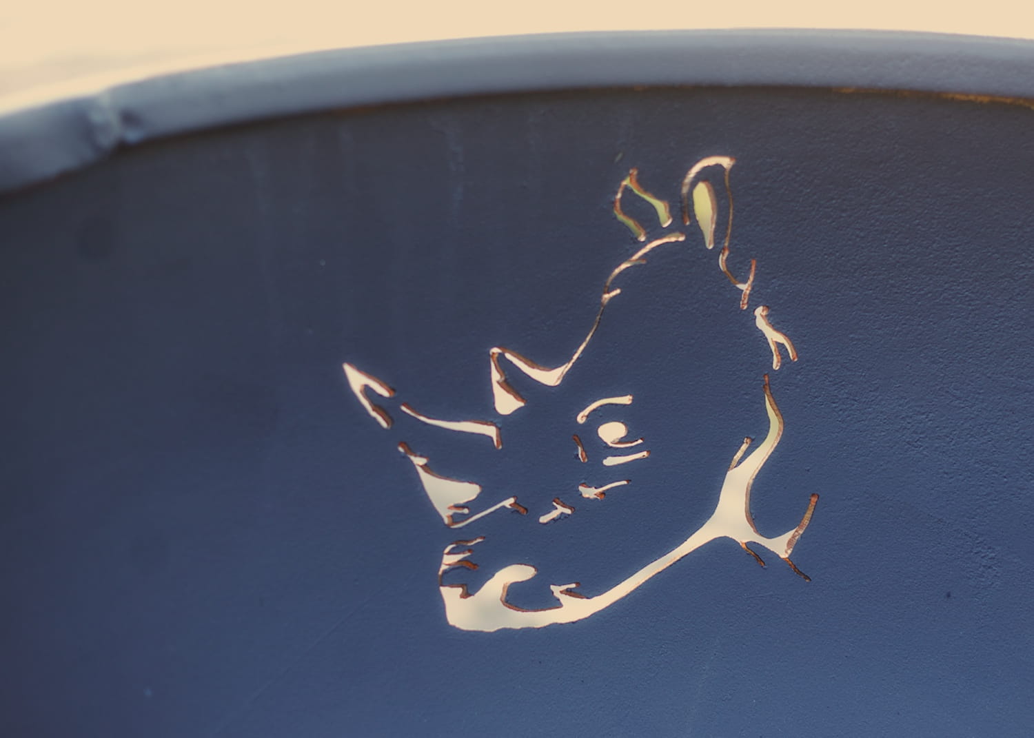 Metallic rhino design on a blue surface
