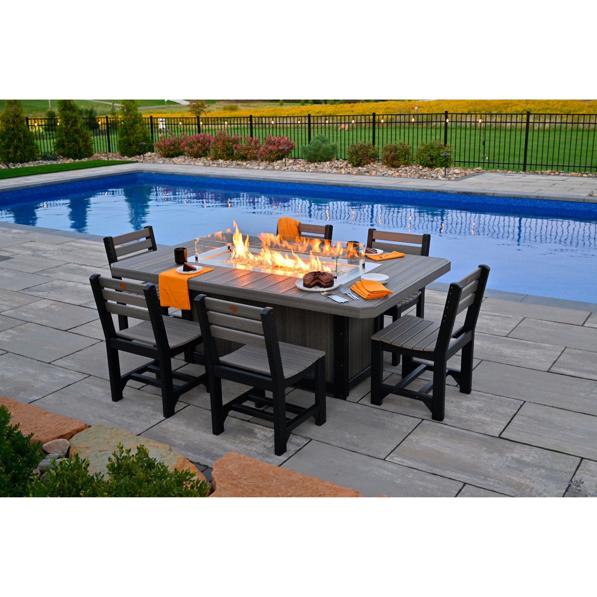 fire table with chairs by a pool