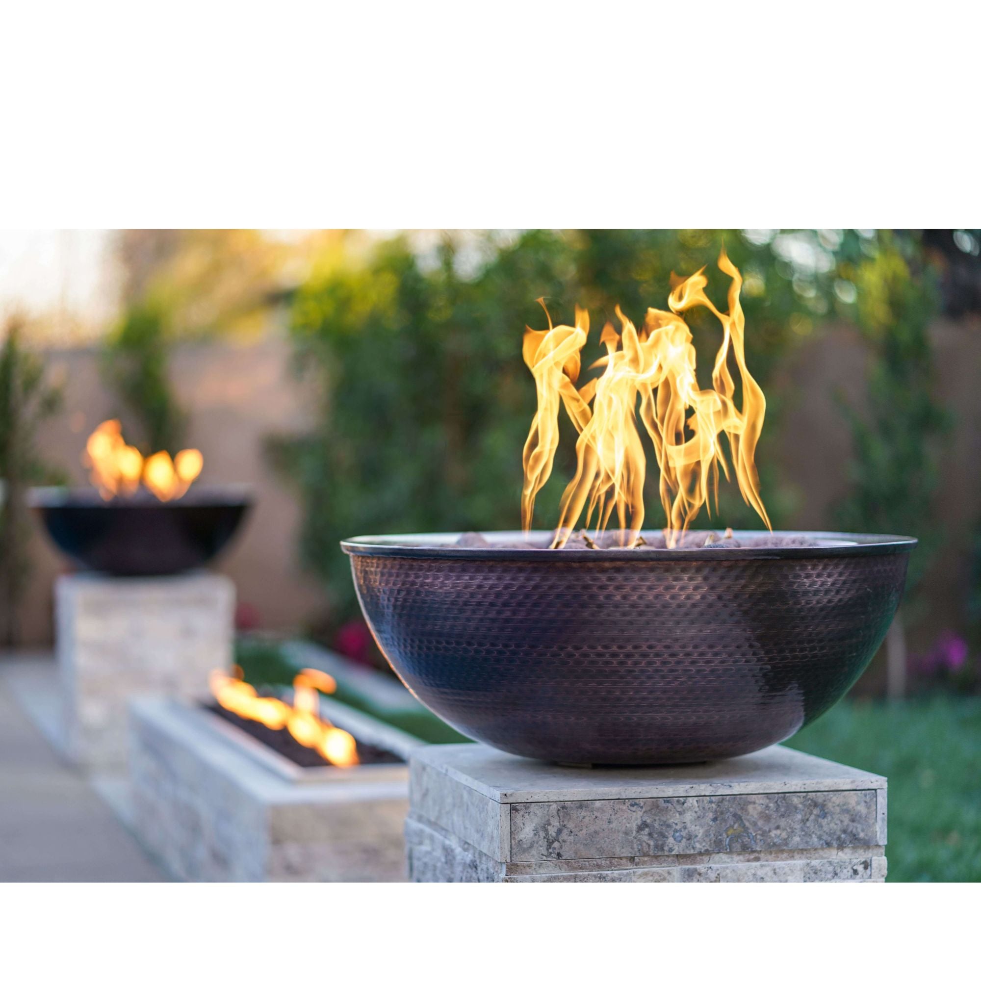 Outdoor fire pit with flames in a garden setting