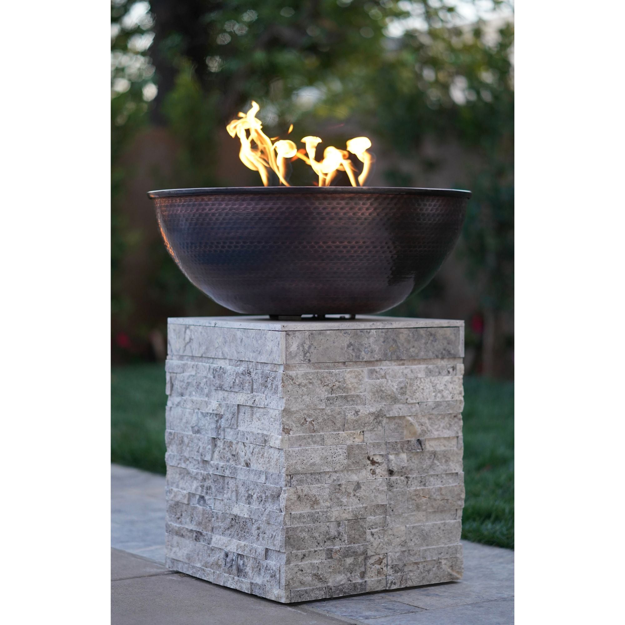 fire bowl with flames on a rock pedestal