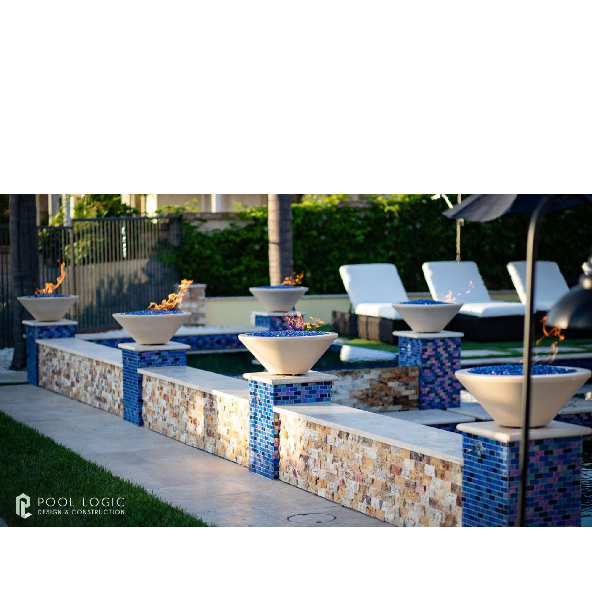 Outdoor pool area with fire bowls and lounge chairs, featuring 'Pool Logic' branding.