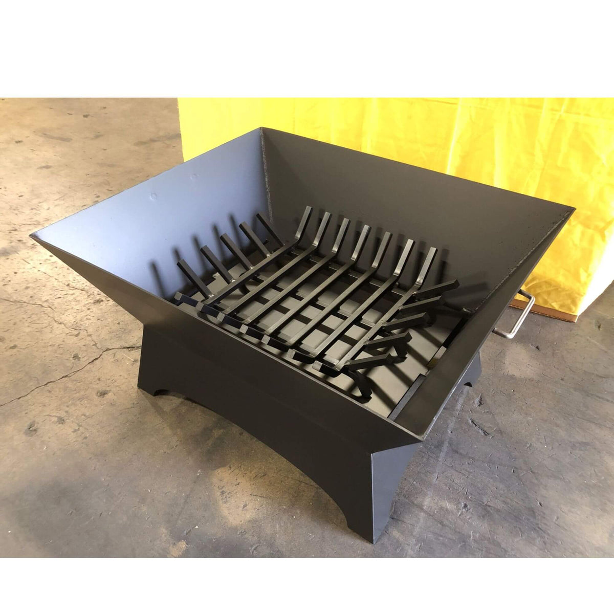 Master Flame square fire pit grate inside a square steel fire pit