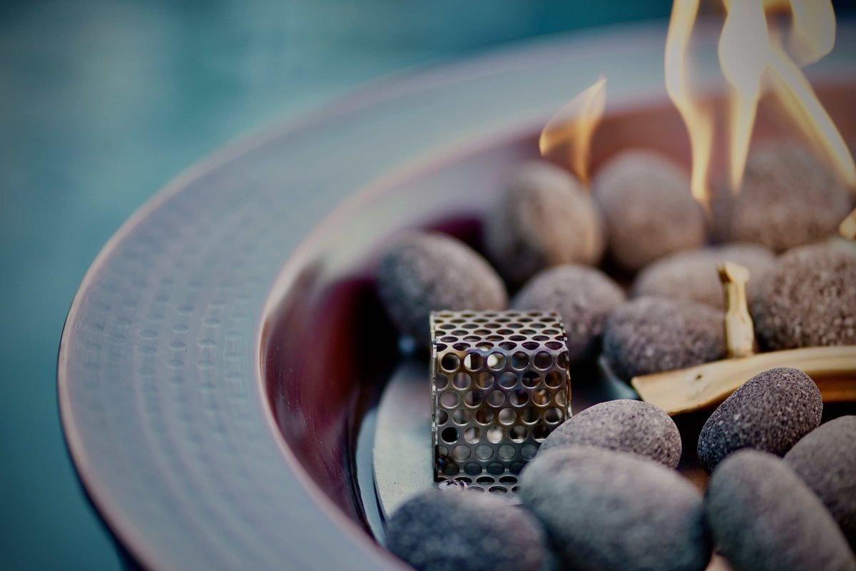 Close-up of a gas fire burning through stones in a fire bowl