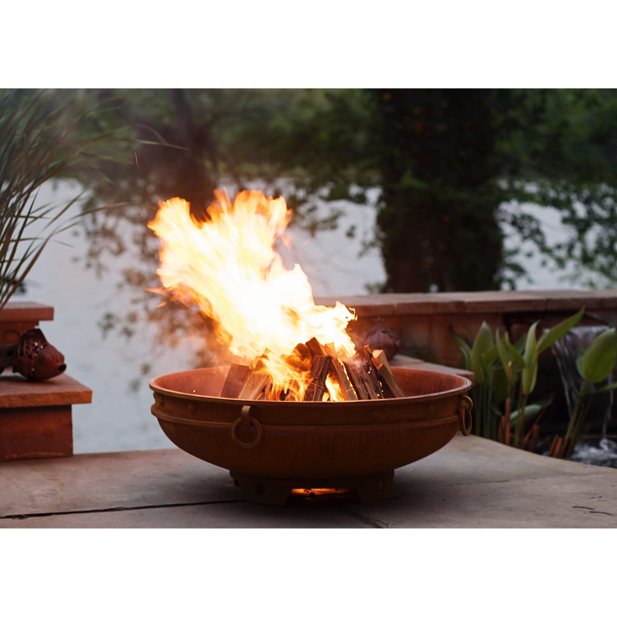 Fire pit with flames burning in an outdoor setting