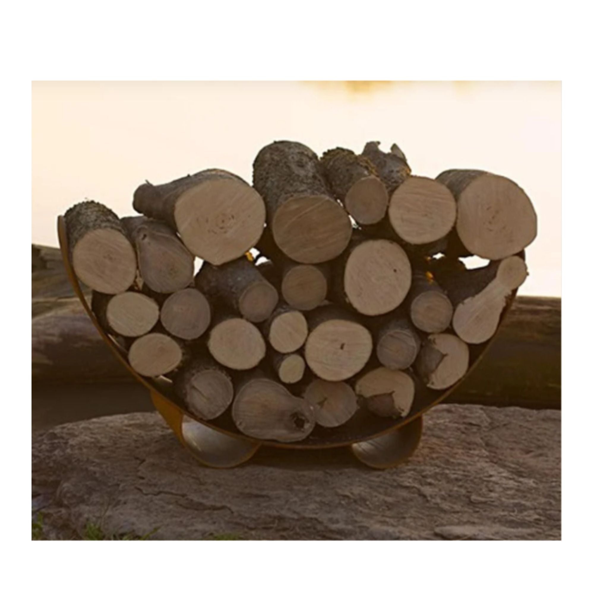 Carbon Steel log holder filled with logs on a stone surface