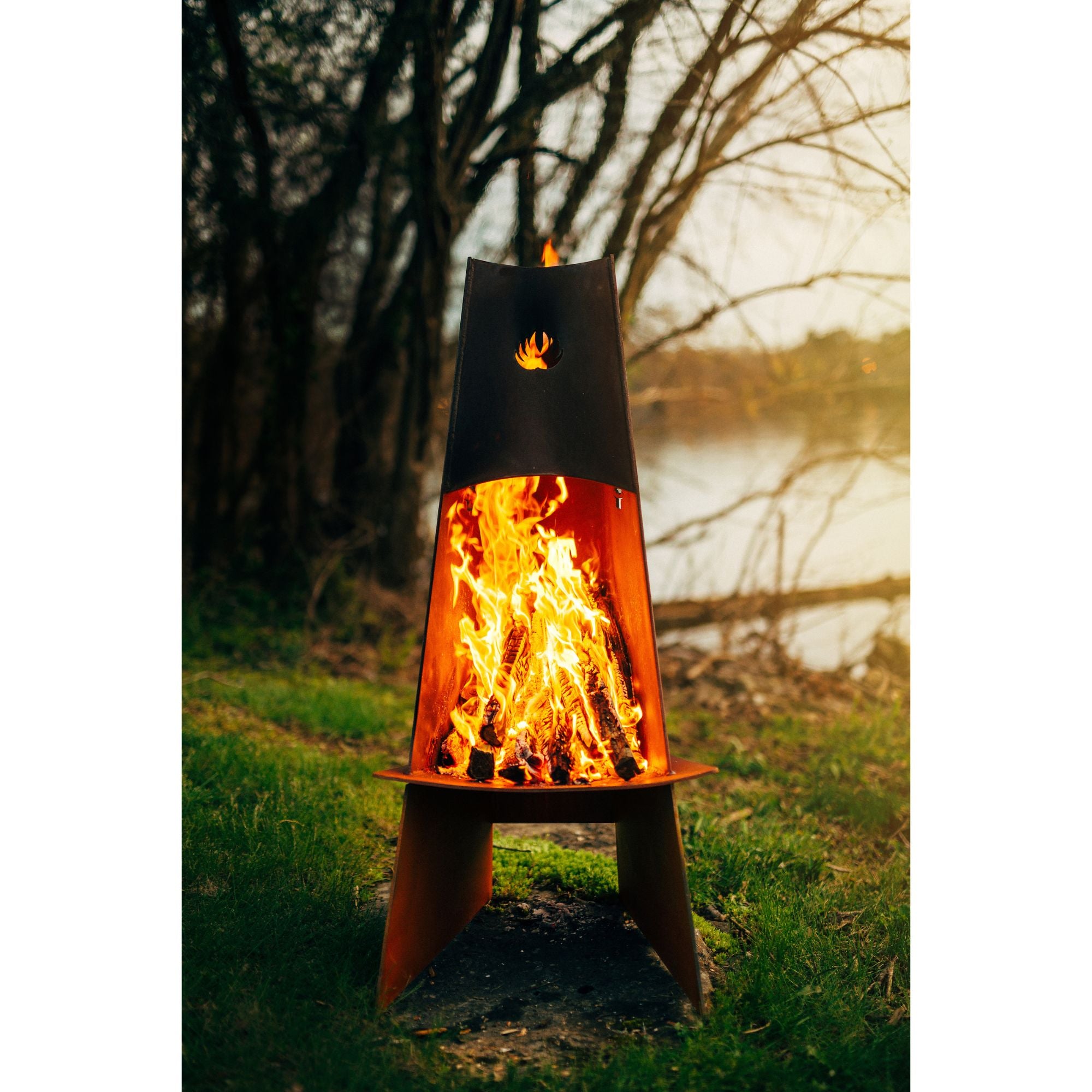 Outdoor fire pit with flames burning in a natural setting