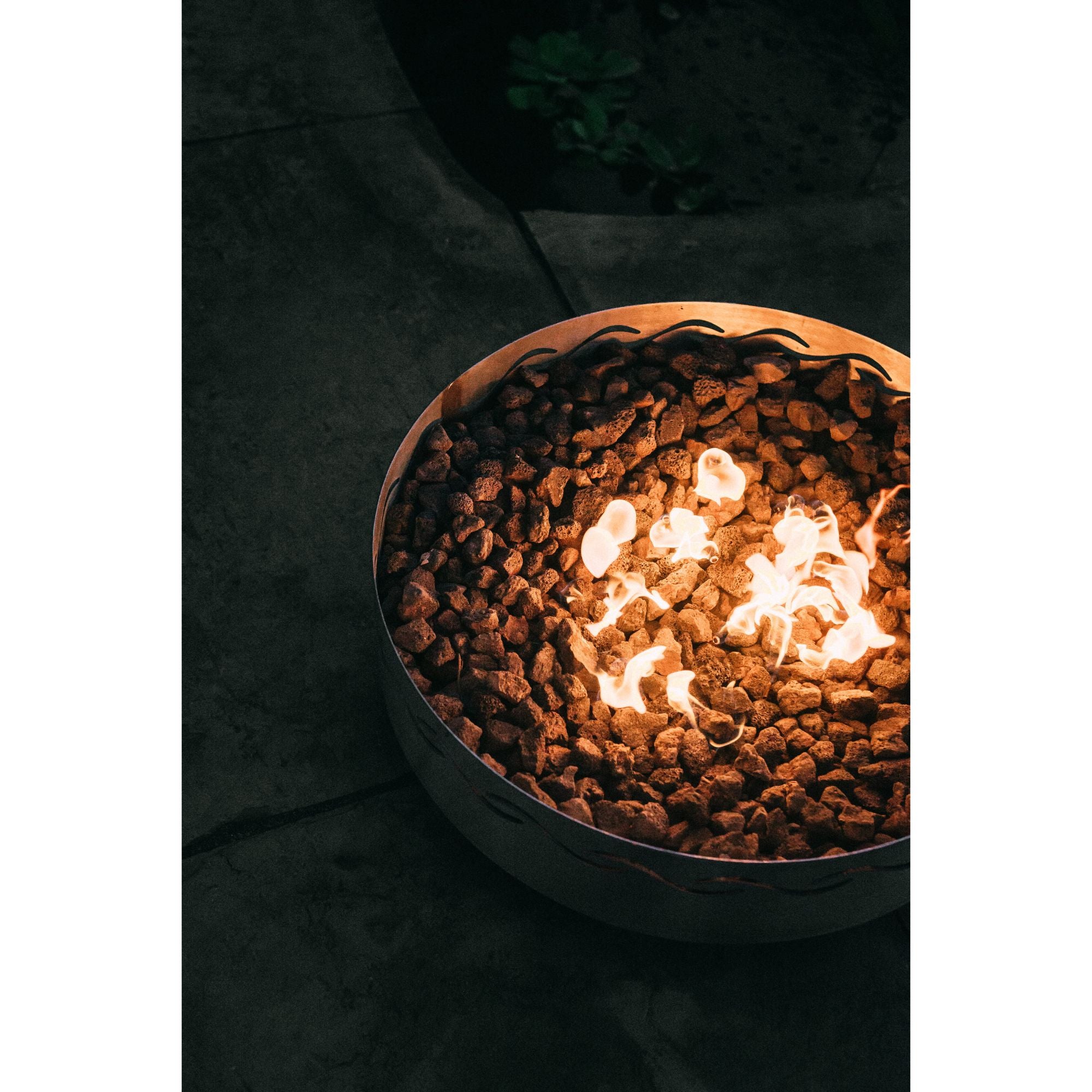 Fire pit with glowing embers on a dark background