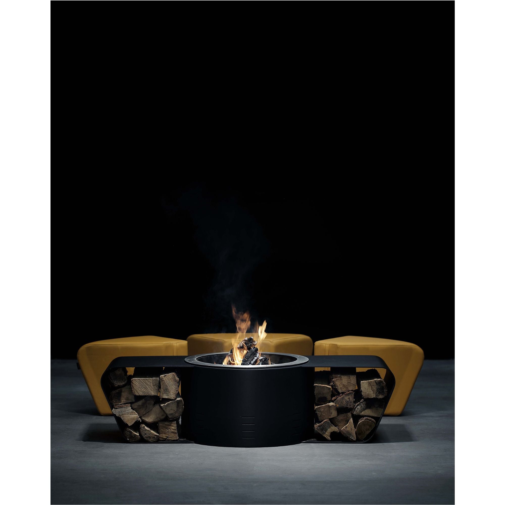 Fire pit with seating area against a black background