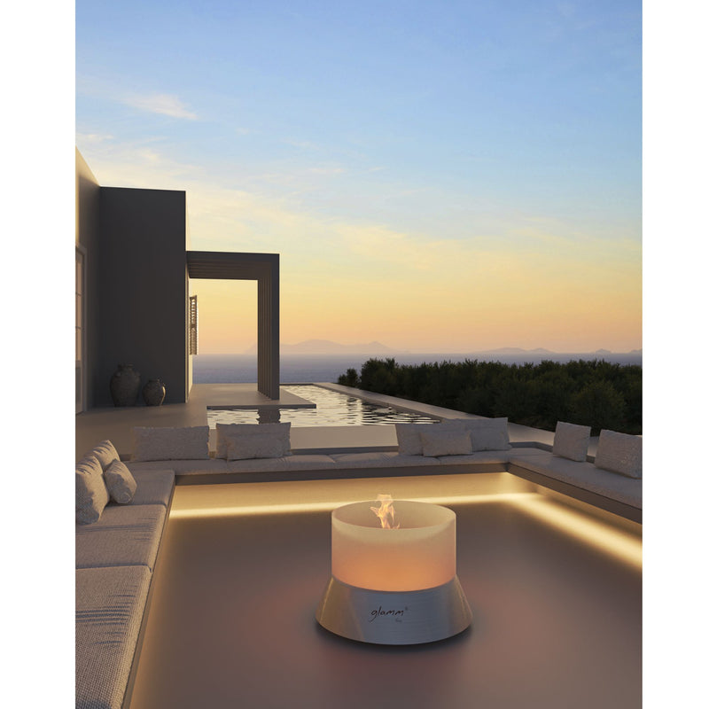 Modern outdoor setting with a fire pit table on a rooftop at sunset.