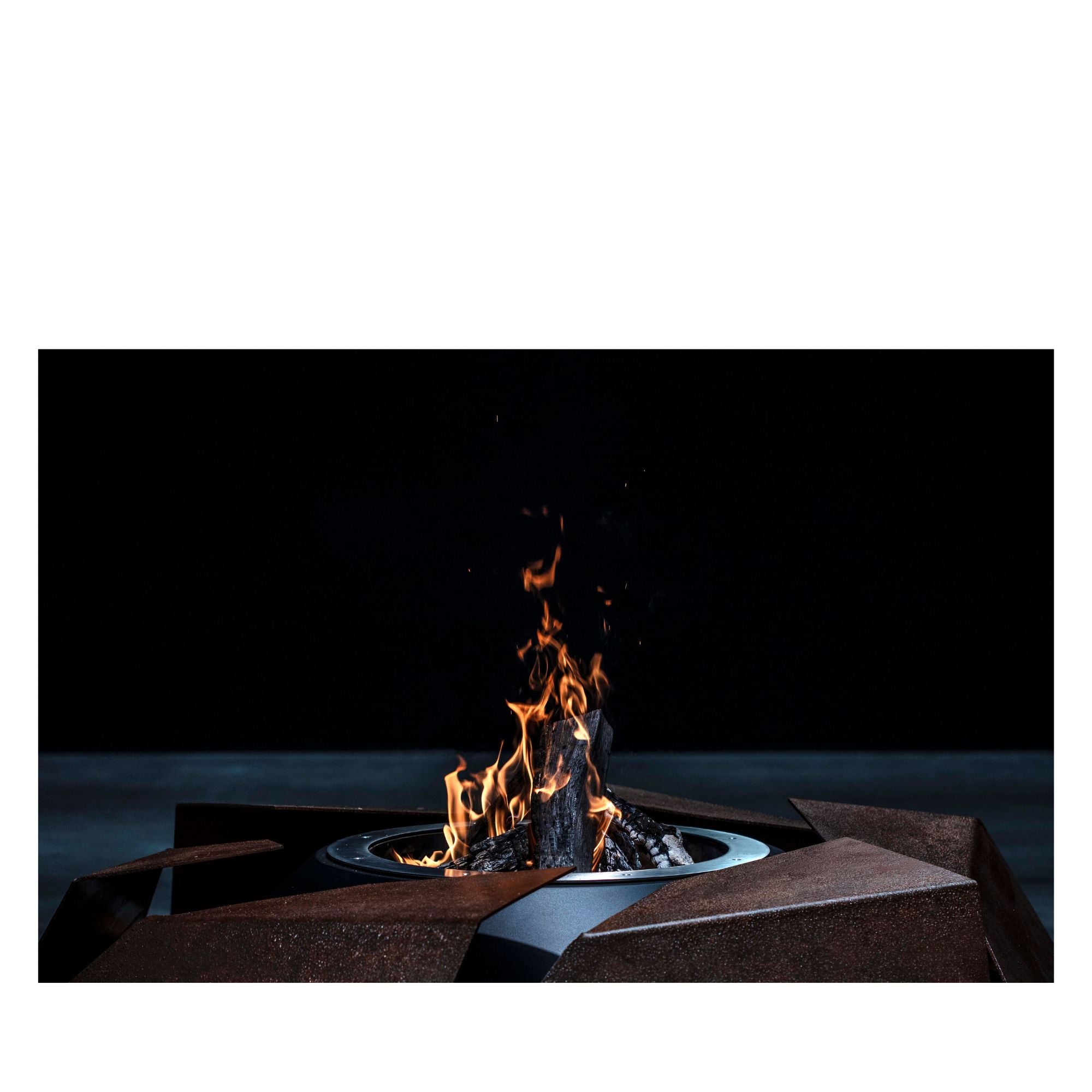 Fire pit with flames burning in a dark setting