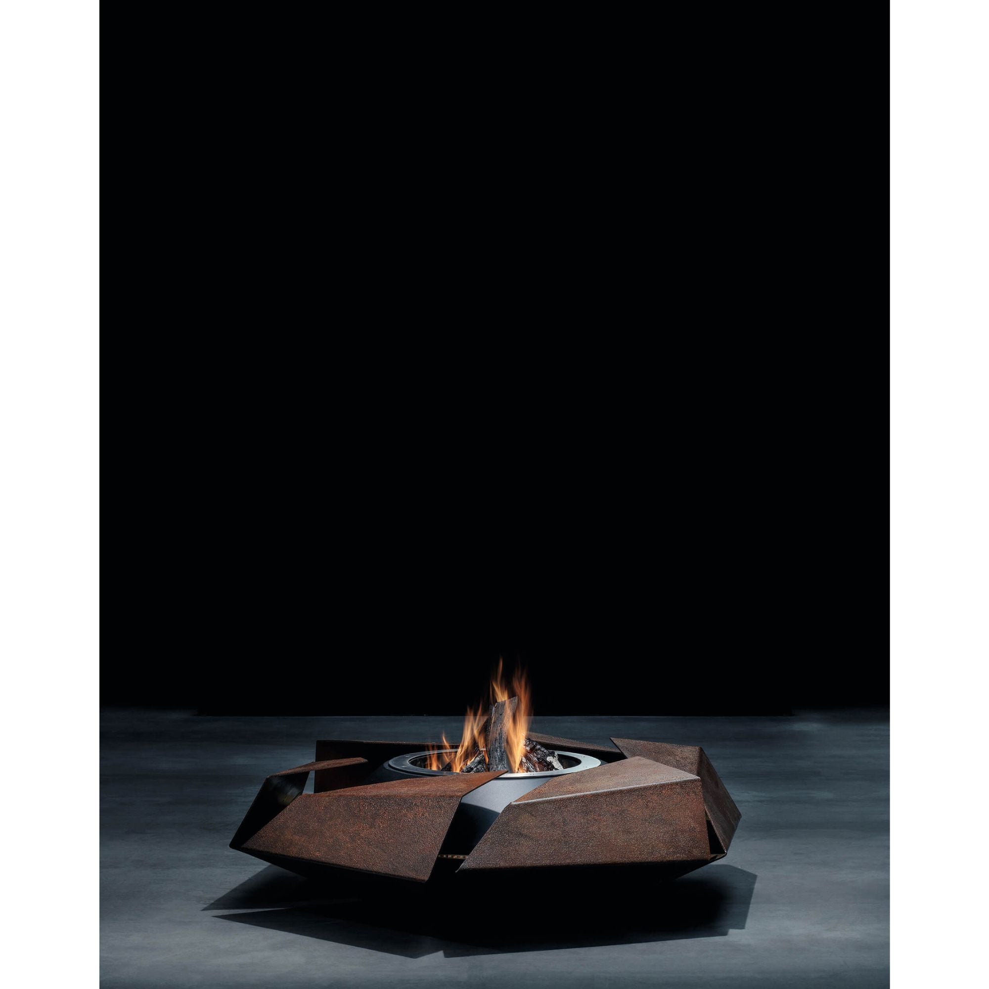 Modern outdoor fire pit with flames on a dark background