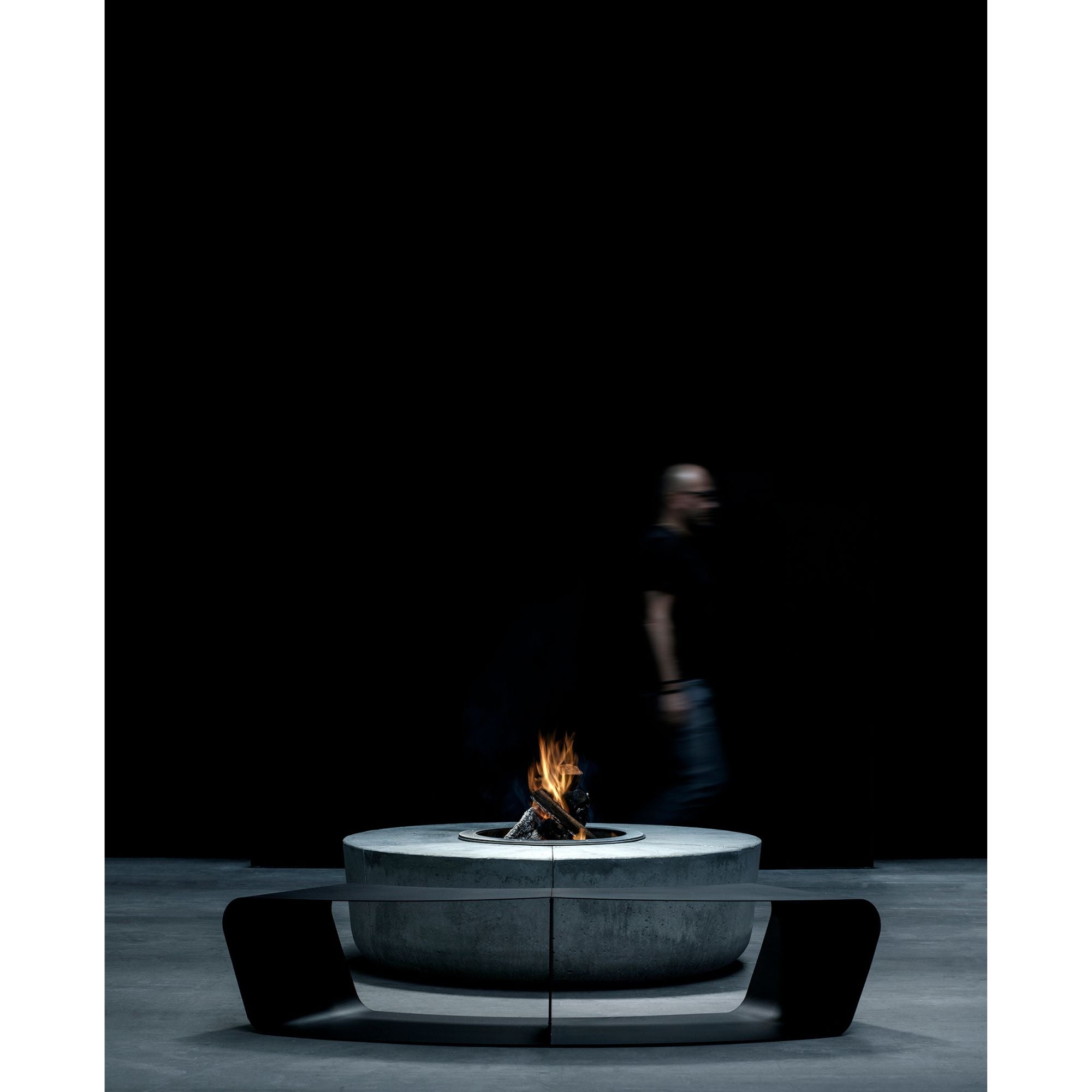 Modern fire pit table with flames on a dark background