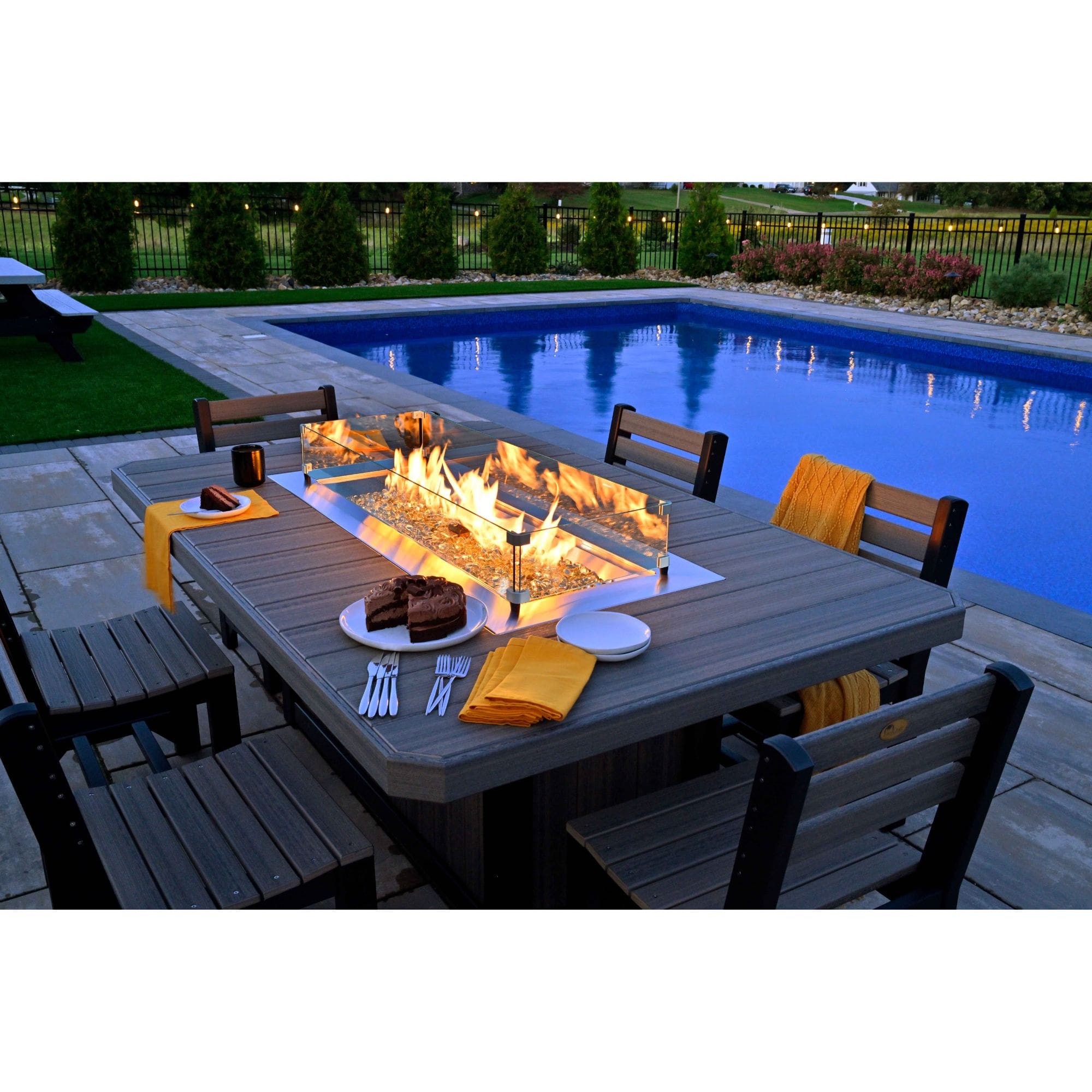 fire table with chairs by a pool