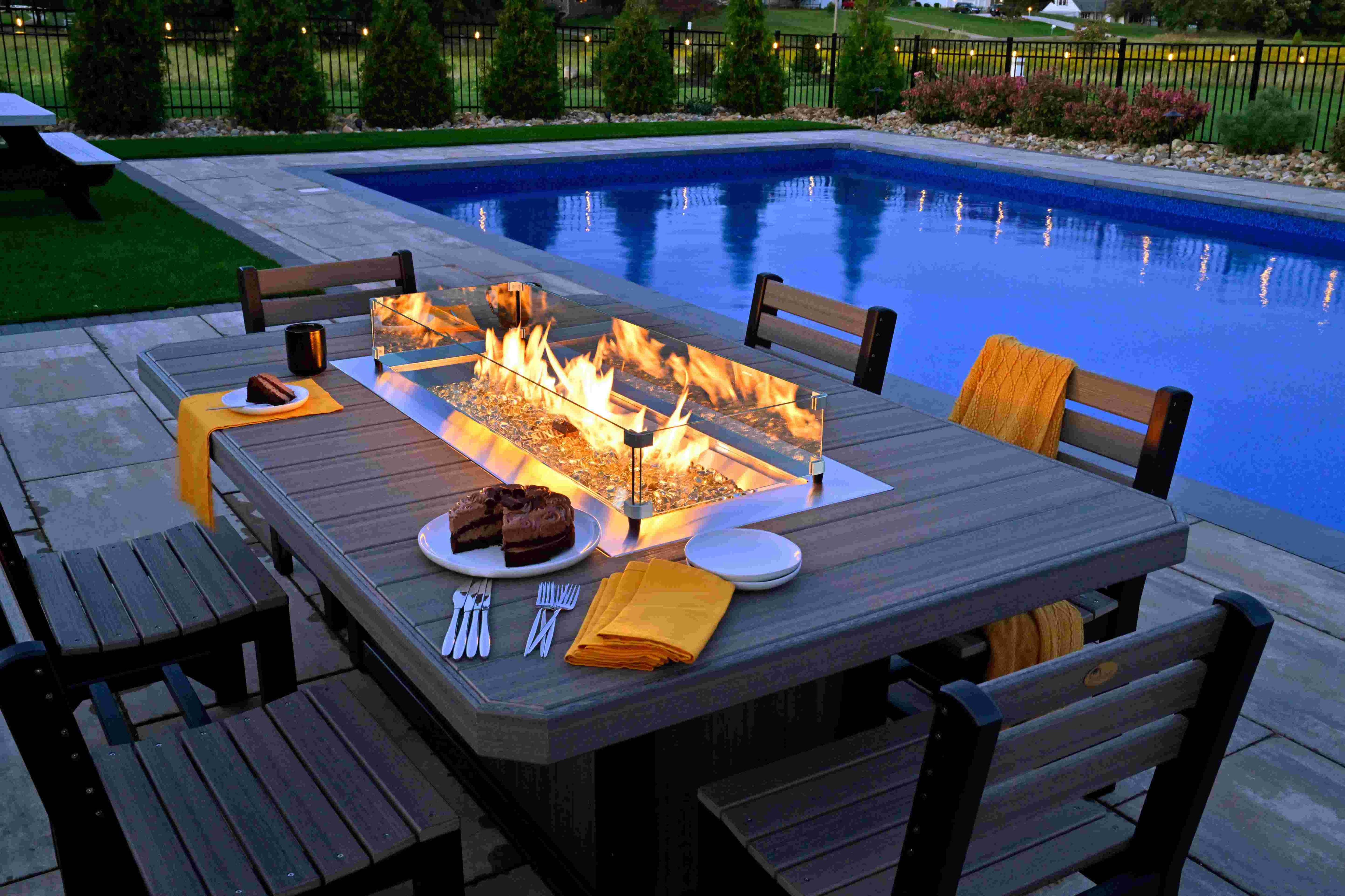 fire pit with flames by a pool
