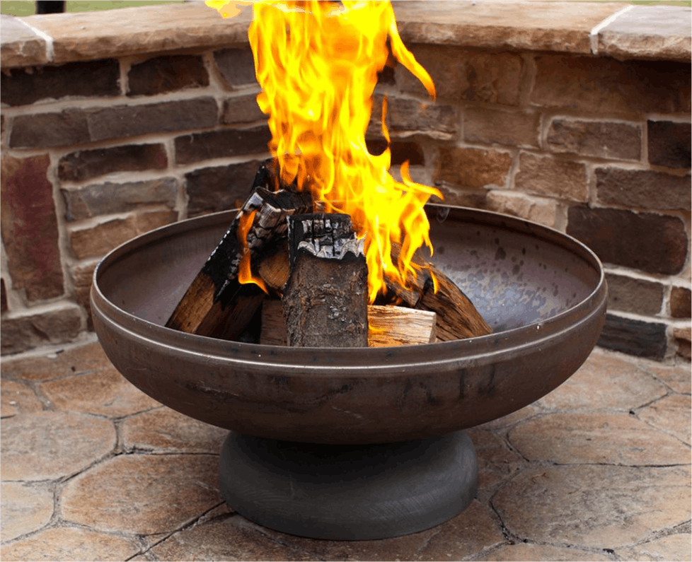 Fire pit with flames burning on a stone patio