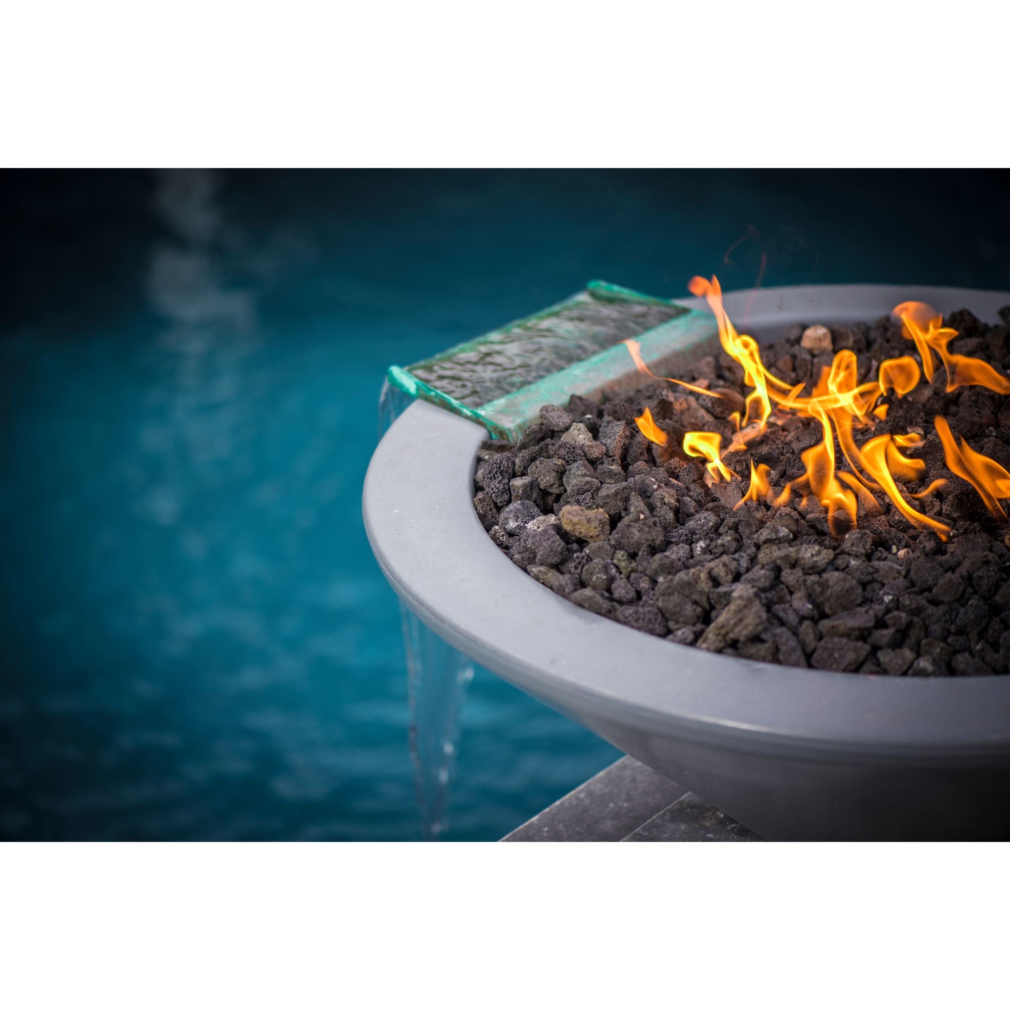 fire and water bowl with flames by a pool