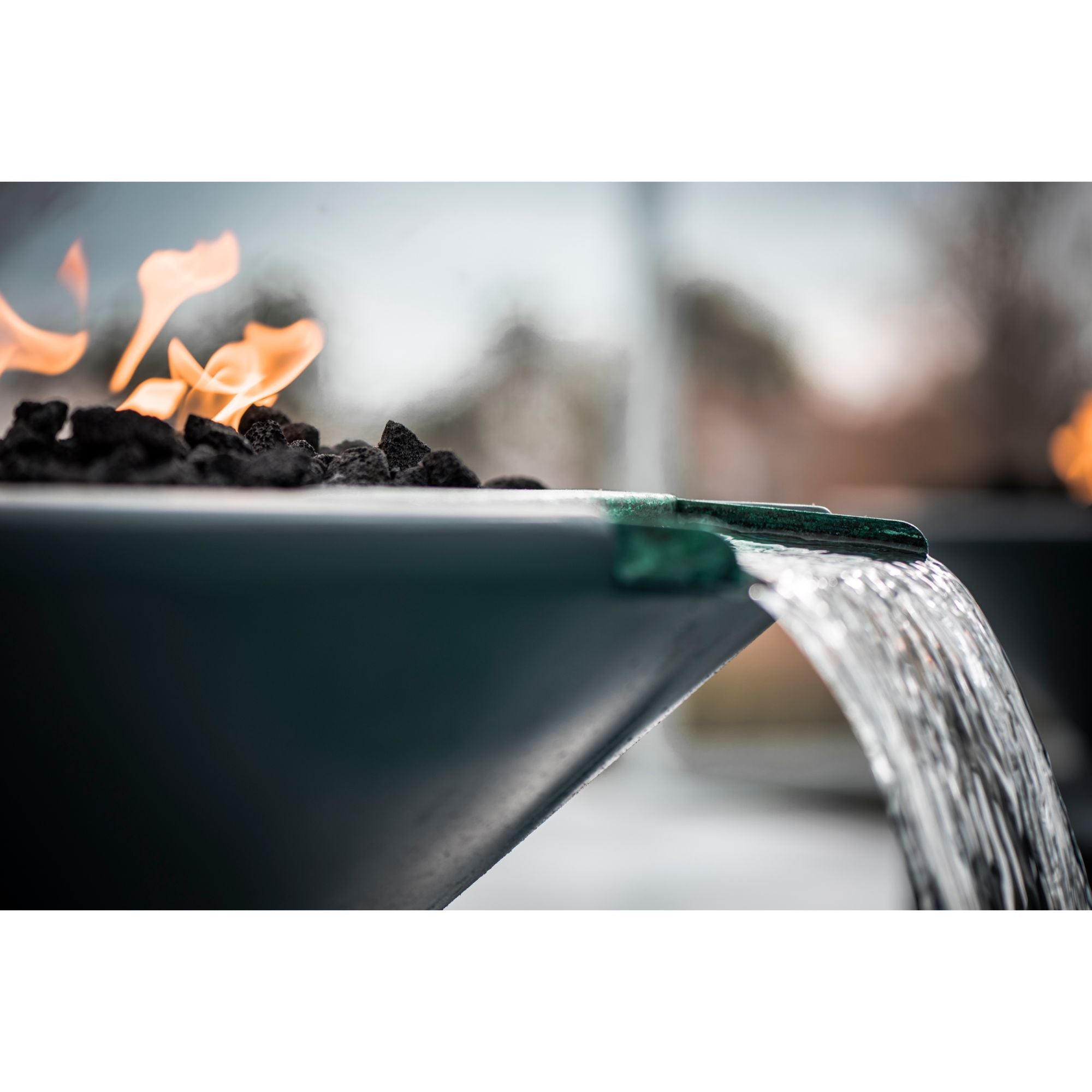 fire and water bowl with flames, with running water from the bowls water scupper