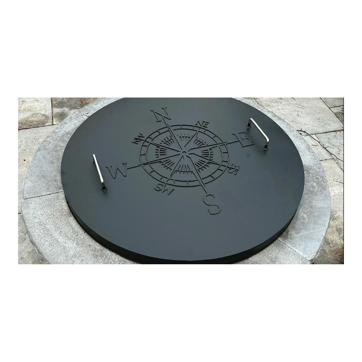Master Flame one piece fire pit cover on a stone fire pit, shown with optional custom compass art