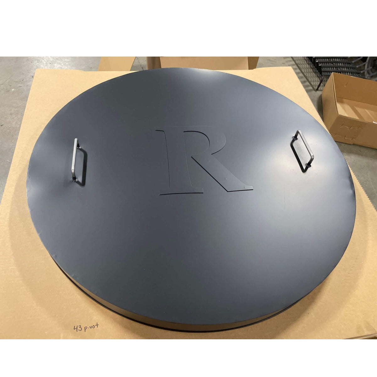 Master Flame one piece round fire pit cover with two handles, shown with optional monogram