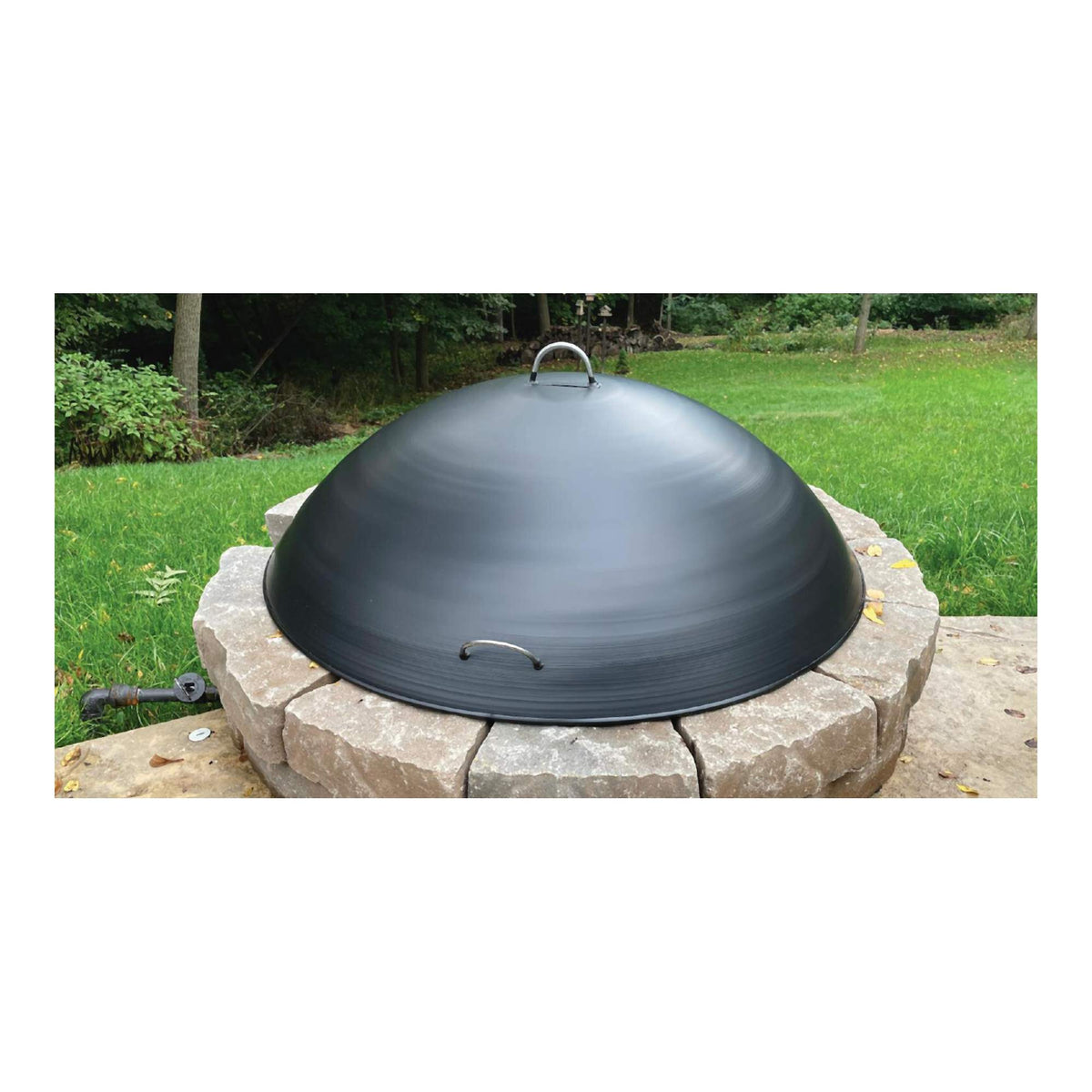 Master Flame round dome fire pit cover snuffer on a stone wood-burning fire pit