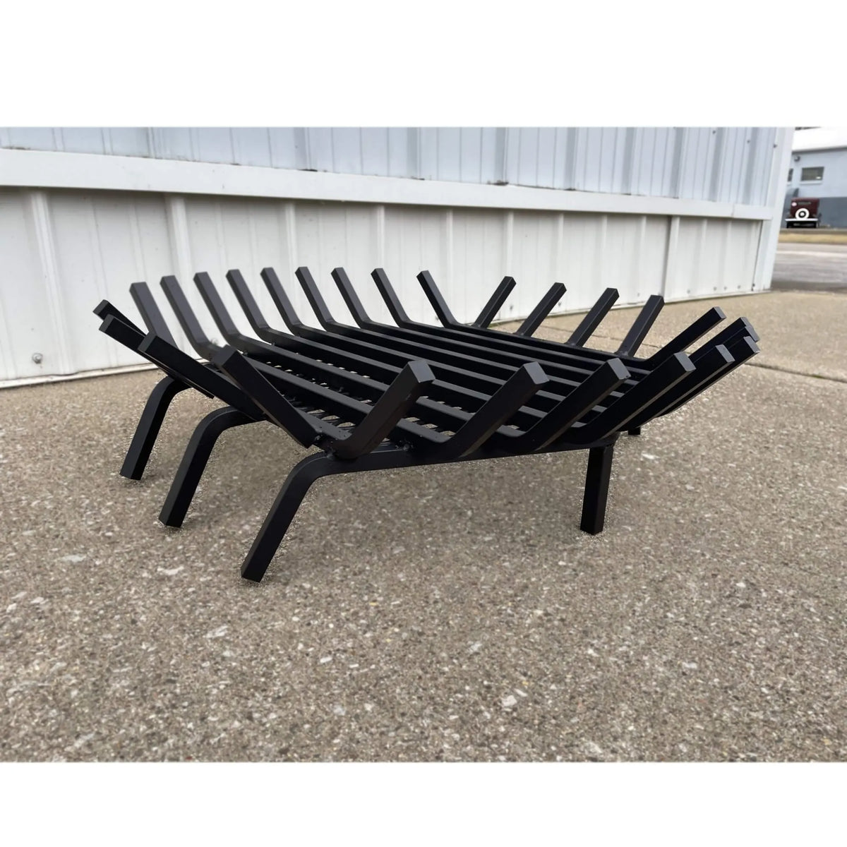 Master Flame round fire pit grate with Char-Guard ember catch, angle view